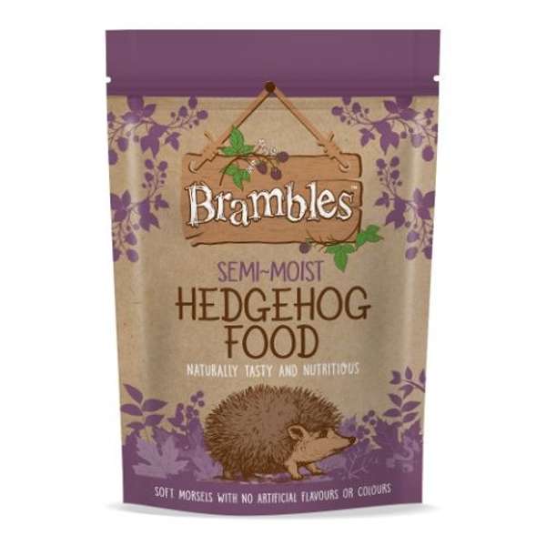 A stand-up pouch of Brambles Semi-Moist Hedgehog Food, featuring a natural brown kraft paper background with purple floral borders, a wooden hanging sign with the Brambles logo, and an illustration of a hedgehog near the bottom.